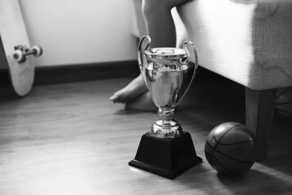 Closeup of trophy on the bedroom floor with basketball grayscale