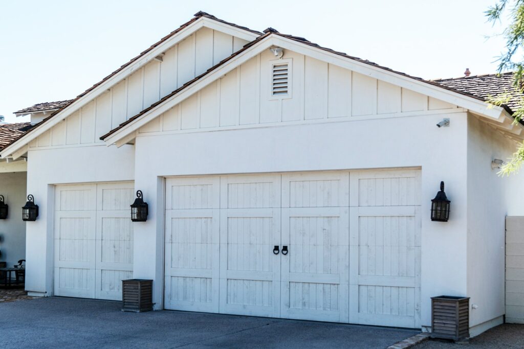 Custom wood carriage garage door that has the appearance of a barn door