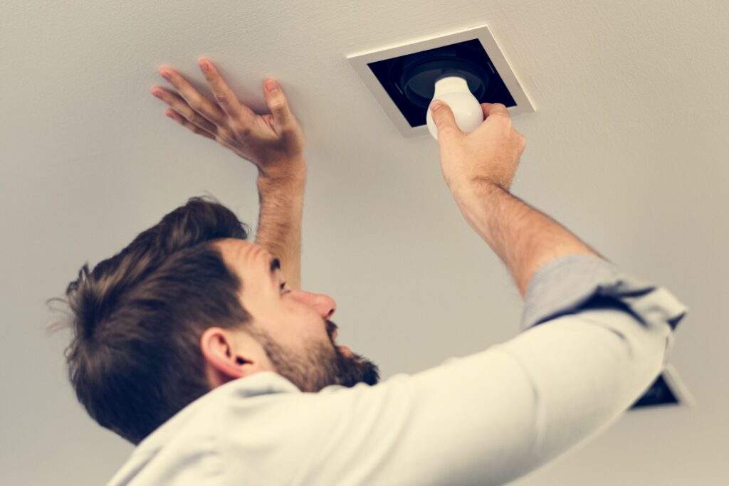 Man changing a light bulb