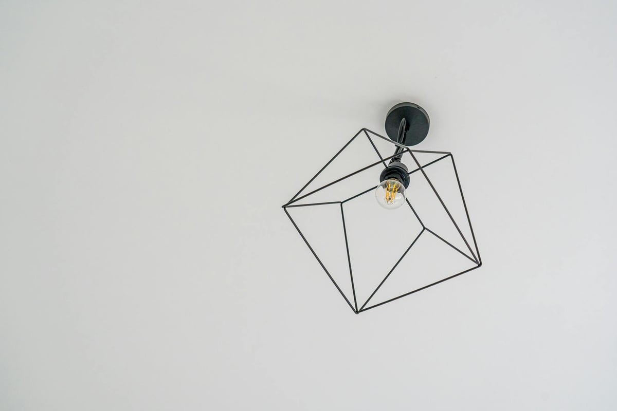 Stylish modern ceiling light fixture with a geometric design on a white background.
